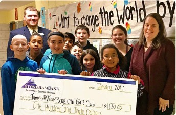 A group of kids holding a StonehamBank check