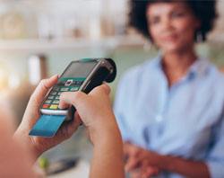 Woman accepting a credit card payment.