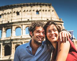 Couple in front of the Roman Colosseum.