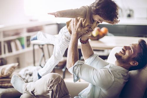 Father holding his son up in the air.