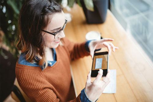 Woman taking an image capture of a check.